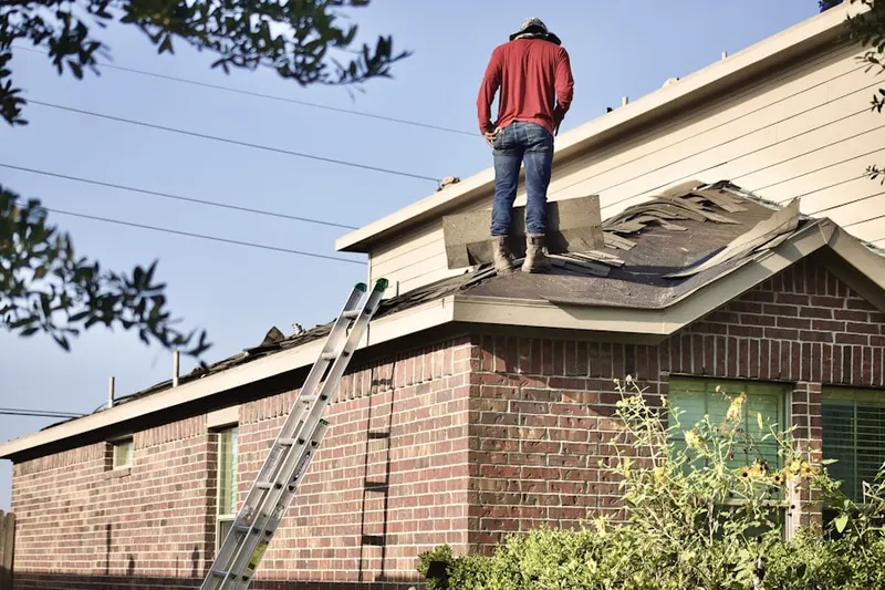 Professional roofer working on a residential roof in Cloverly Acres